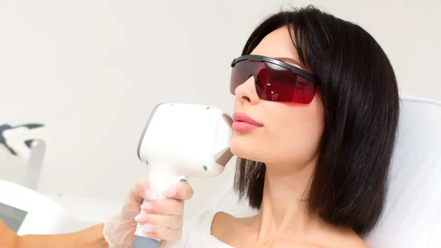 Woman receiving non-surgical BBL treatment for sun damage